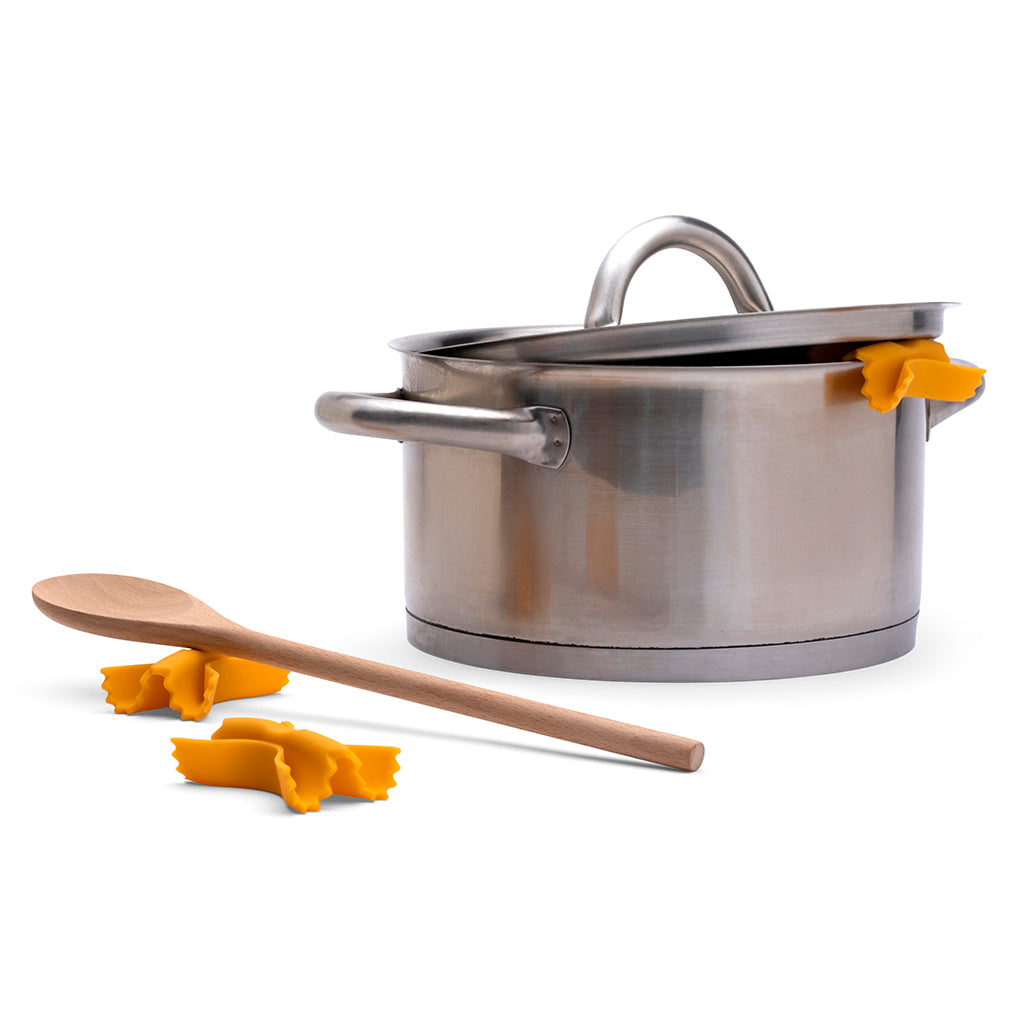 Kitchen steam tool shaped like pasta resting on pot rim
by Monkey Business