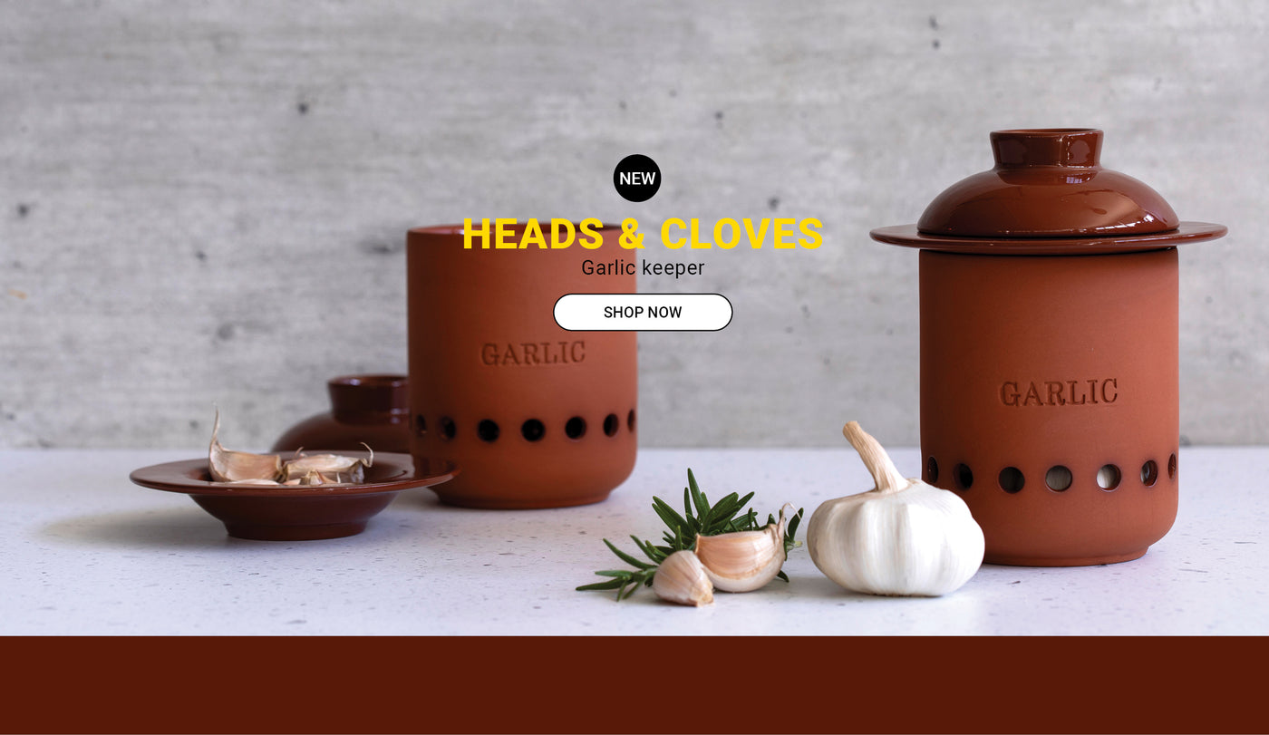 Heads & Cloves – terracotta garlic keeper with charm kitchen counter