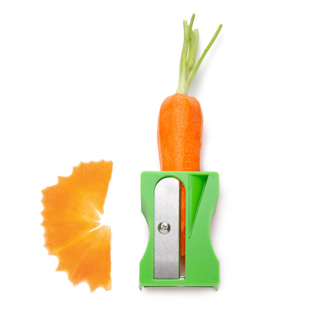 Pencil-style veggie peeler shaping vegetables into ribbons